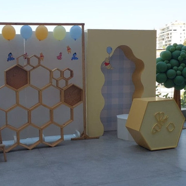 Birthday with Winnie the Pooh and honeycomb decorations.
