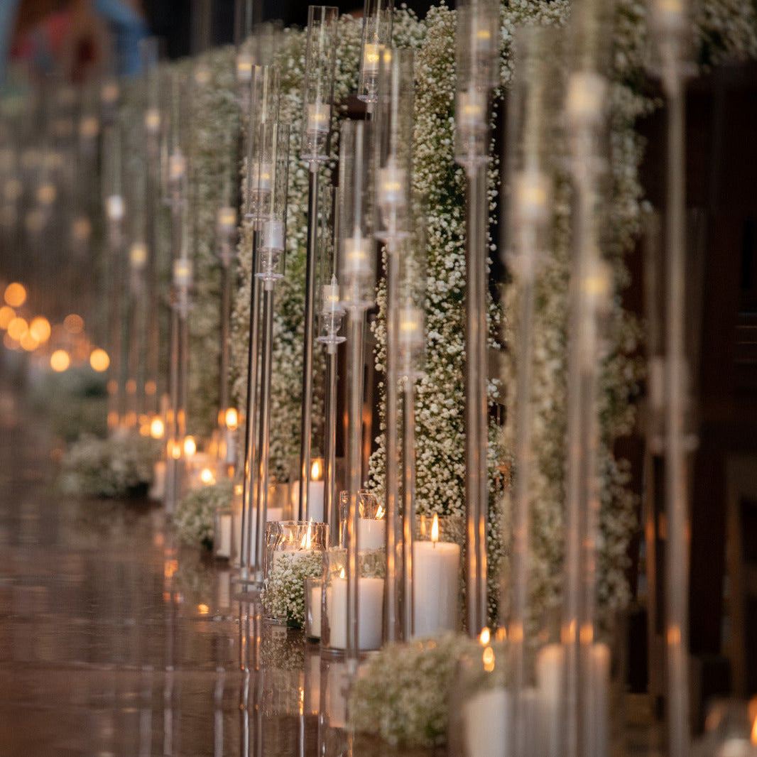 Decorative setup with candles and flowers on a table, blurred background
