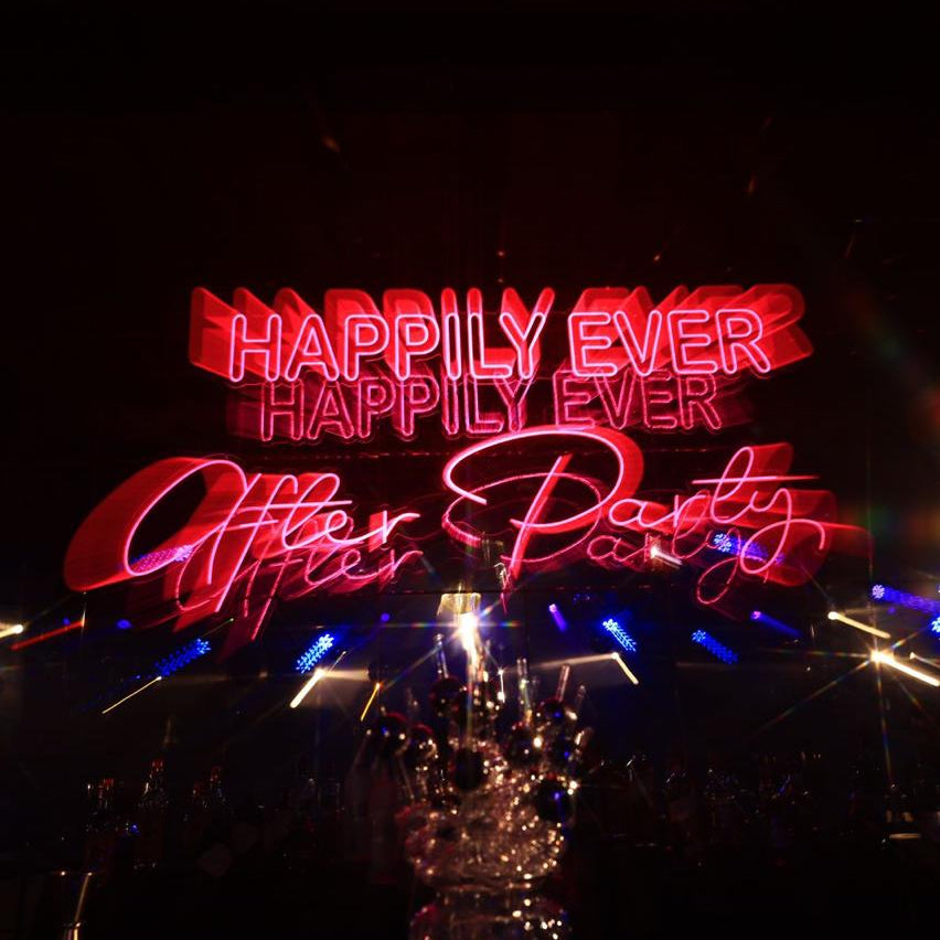 Neon sign with 'Happily Ever Happily Ever After Party' text in an after party 