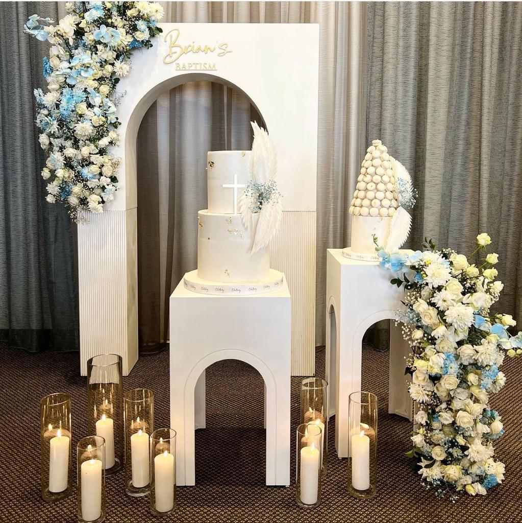 Decorative setup with a cake, flowers, and candles on a patterned floor.
Backdrops for rental and event