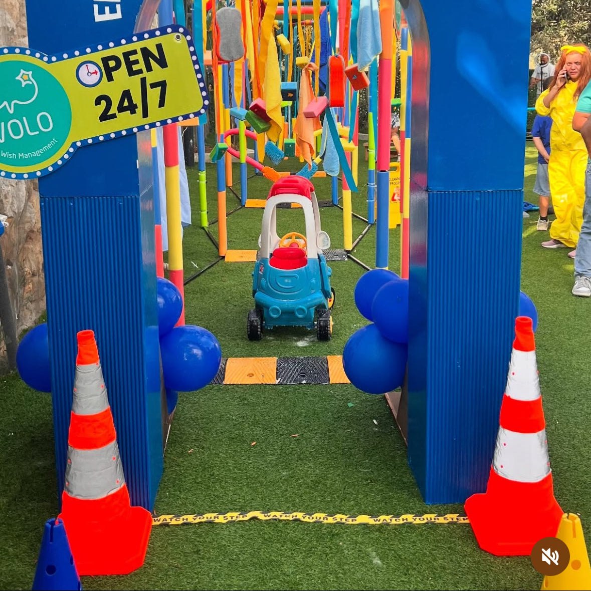 Play area with colorful equipment and a 'Junior's Car Wash' sign.