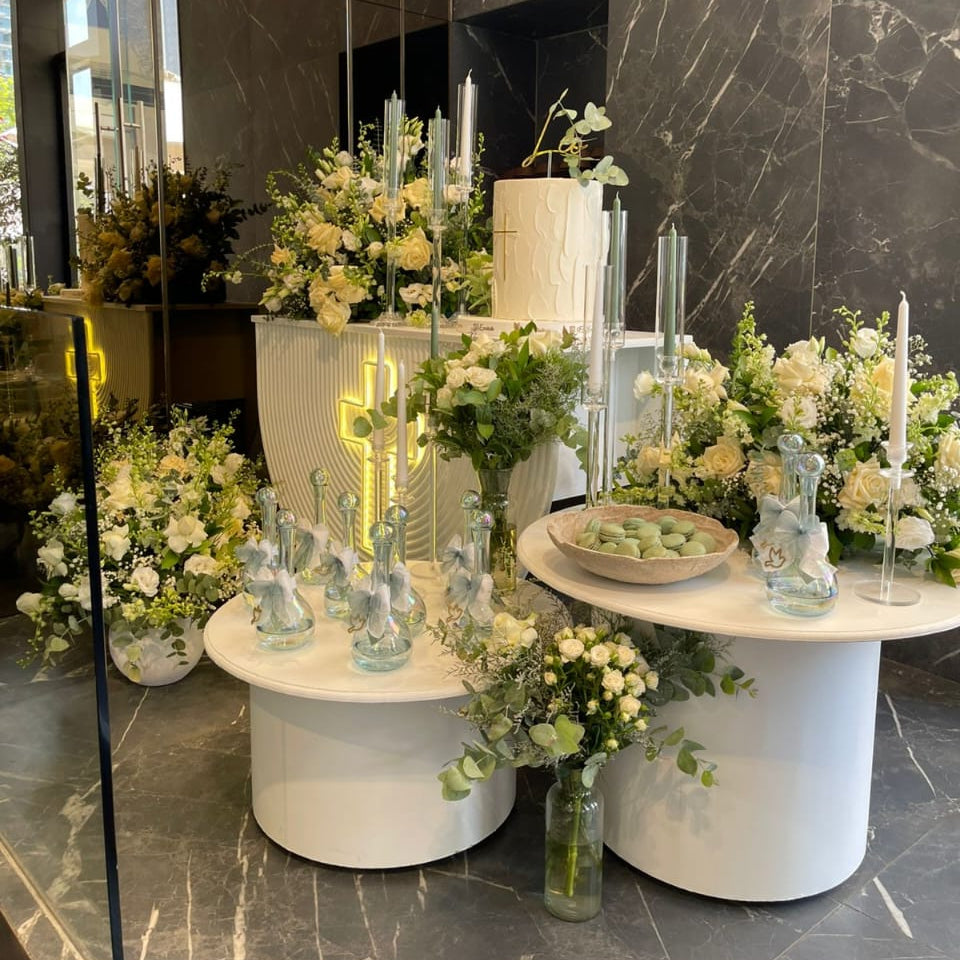 Decorative table setup with flowers and candles in a modern interior setting.
