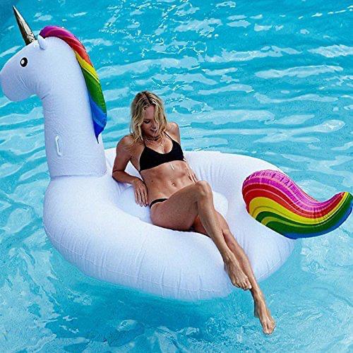 Woman sitting on a unicorn-shaped inflatable pool float in a pool