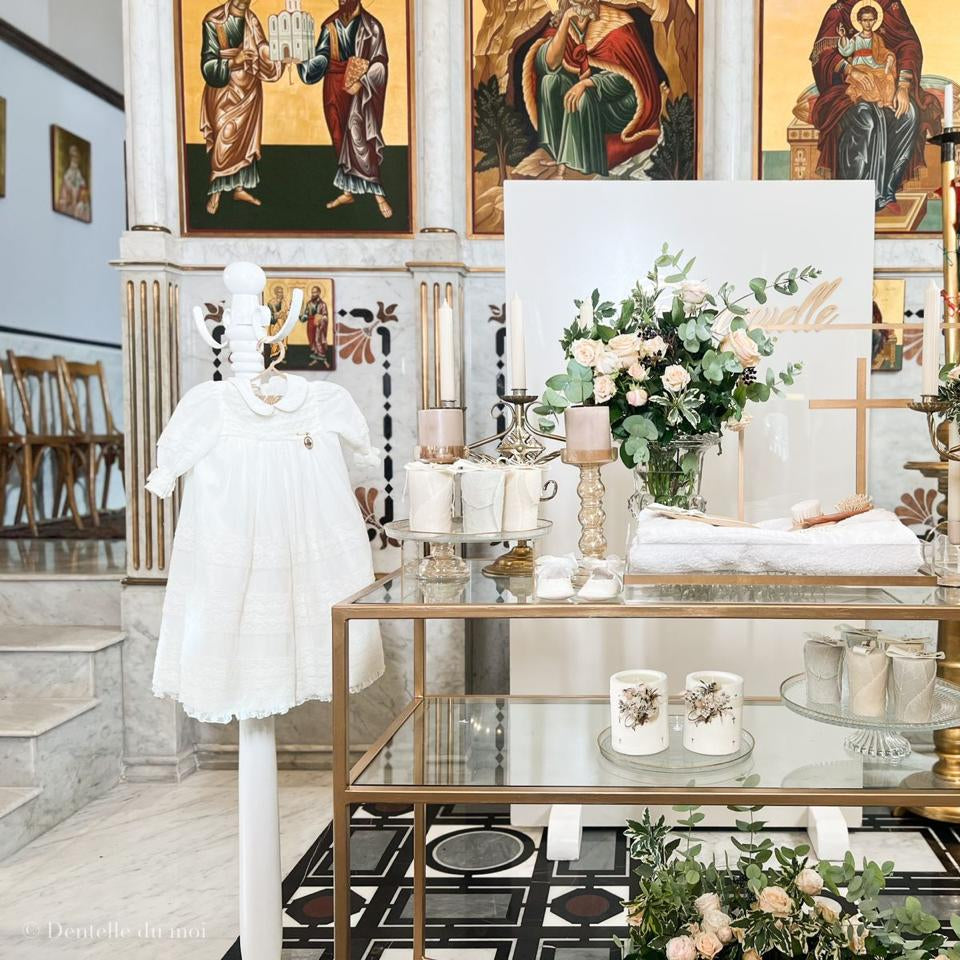 Decorative interior with a glass table, flowers, and religious iconography.