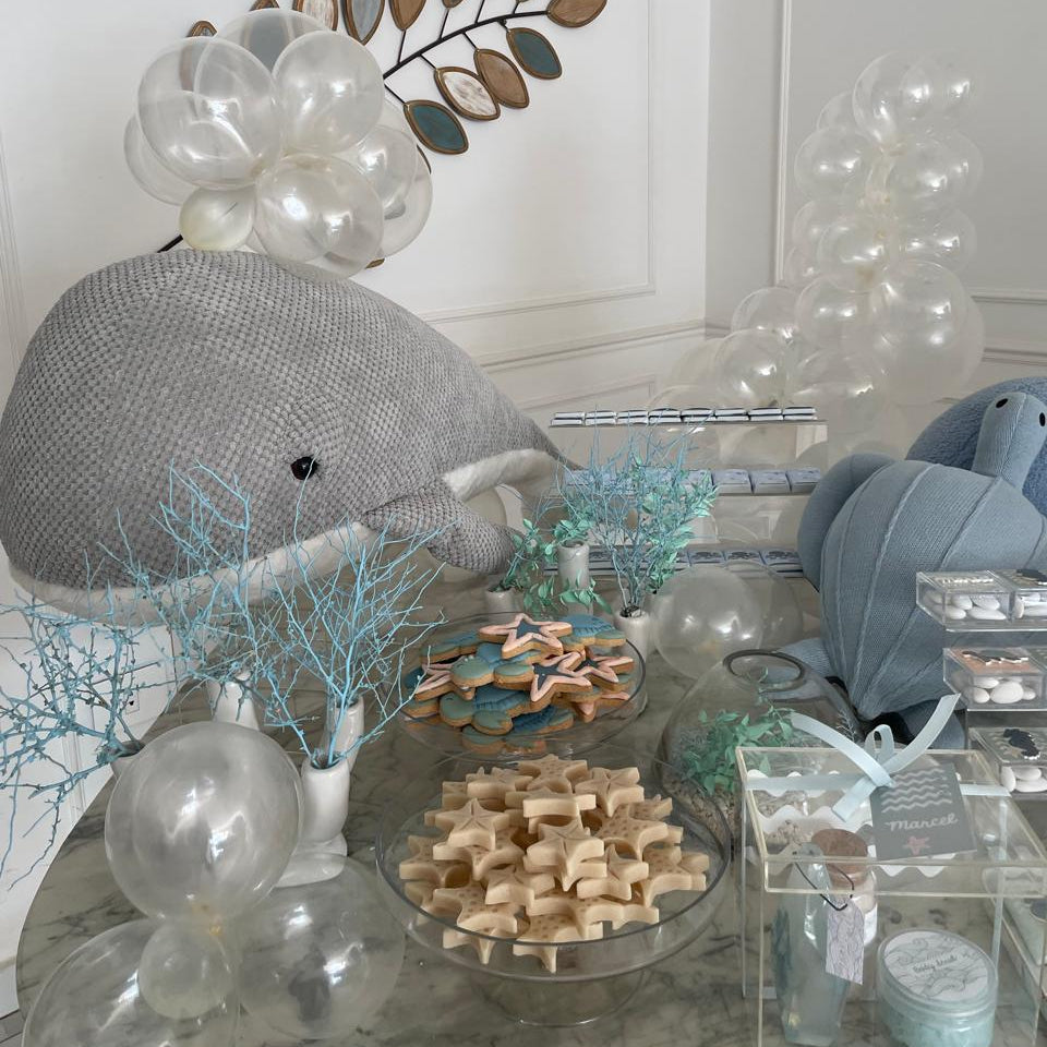 Display of trays with animal shapes on a decorative table for a newborn setup under the sea.