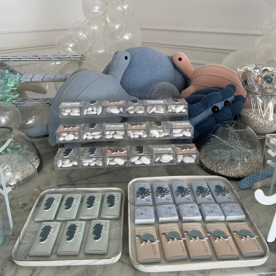 Display of trays with animal shapes on a decorative table for a newborn setup under the sea.