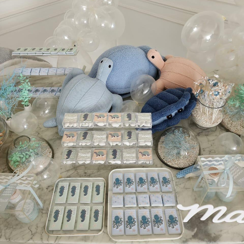 Display of trays with animal shapes on a decorative table for a newborn setup under the sea.