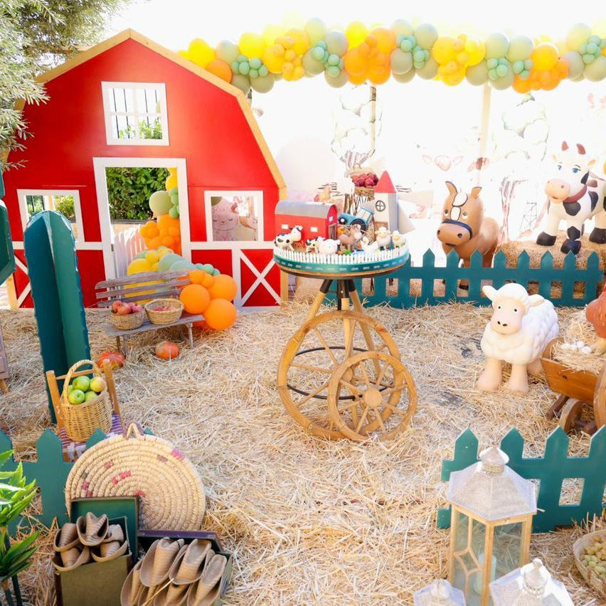 Children's birthday with a barn, animals, and festive decorations.