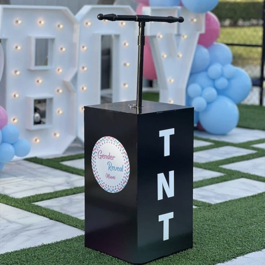 Black TNT-themed stand with 'Girly or Boy' decoration in the background