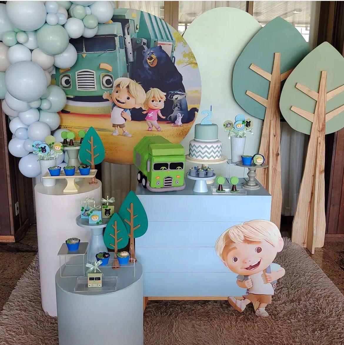 Children's birthday party setup with cartoon character decorations, balloons, and a cake.