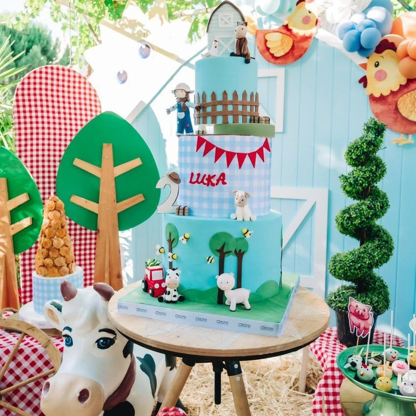 Children's play area with a small wooden house, toys, and decorative elements in an outdoor setting.