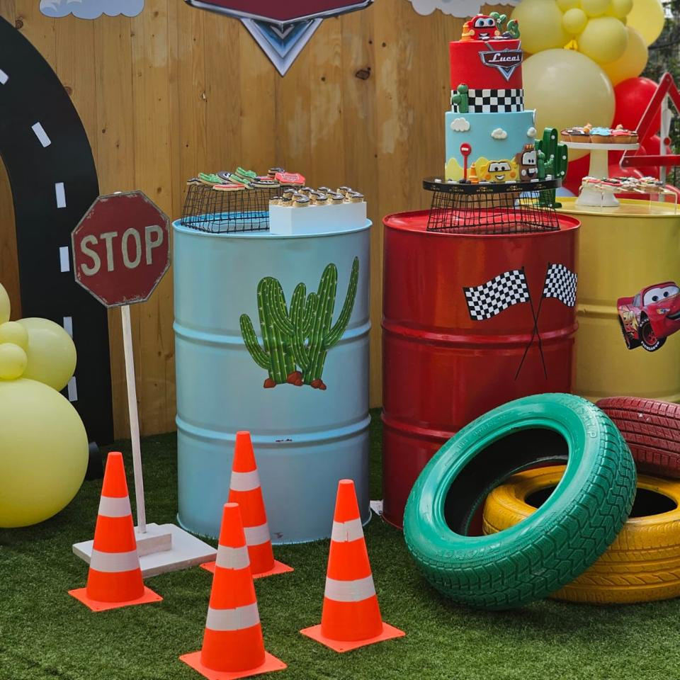 Children's birthday party setup with balloons, cake, and themed decorations.