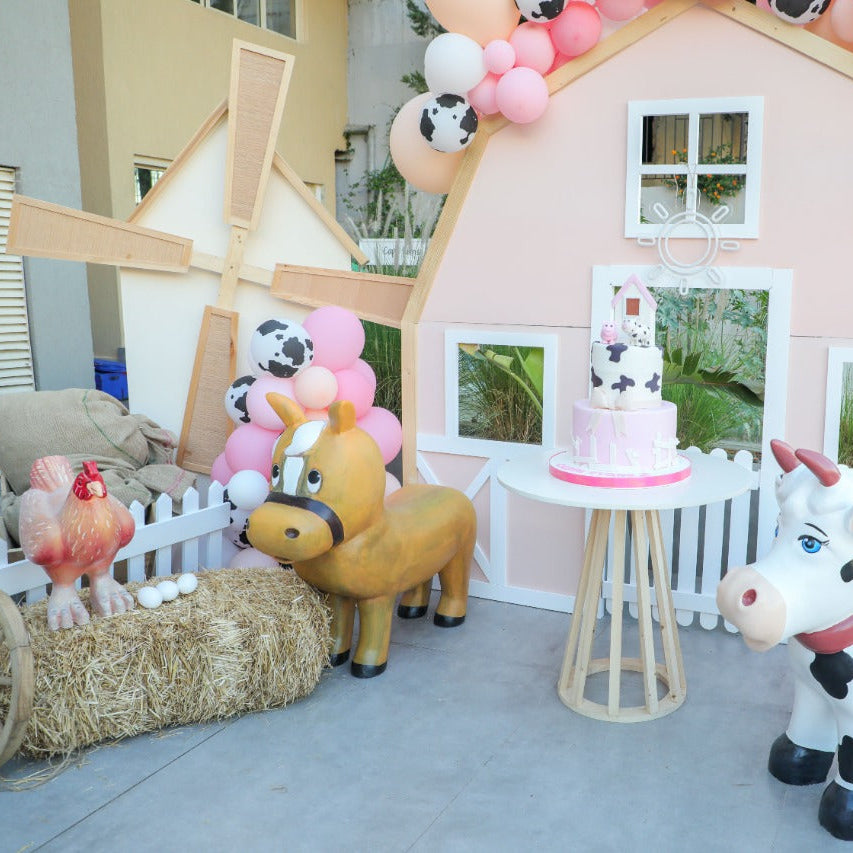 Children's Birthday with animals, a cake, and balloons in front of a small barn.