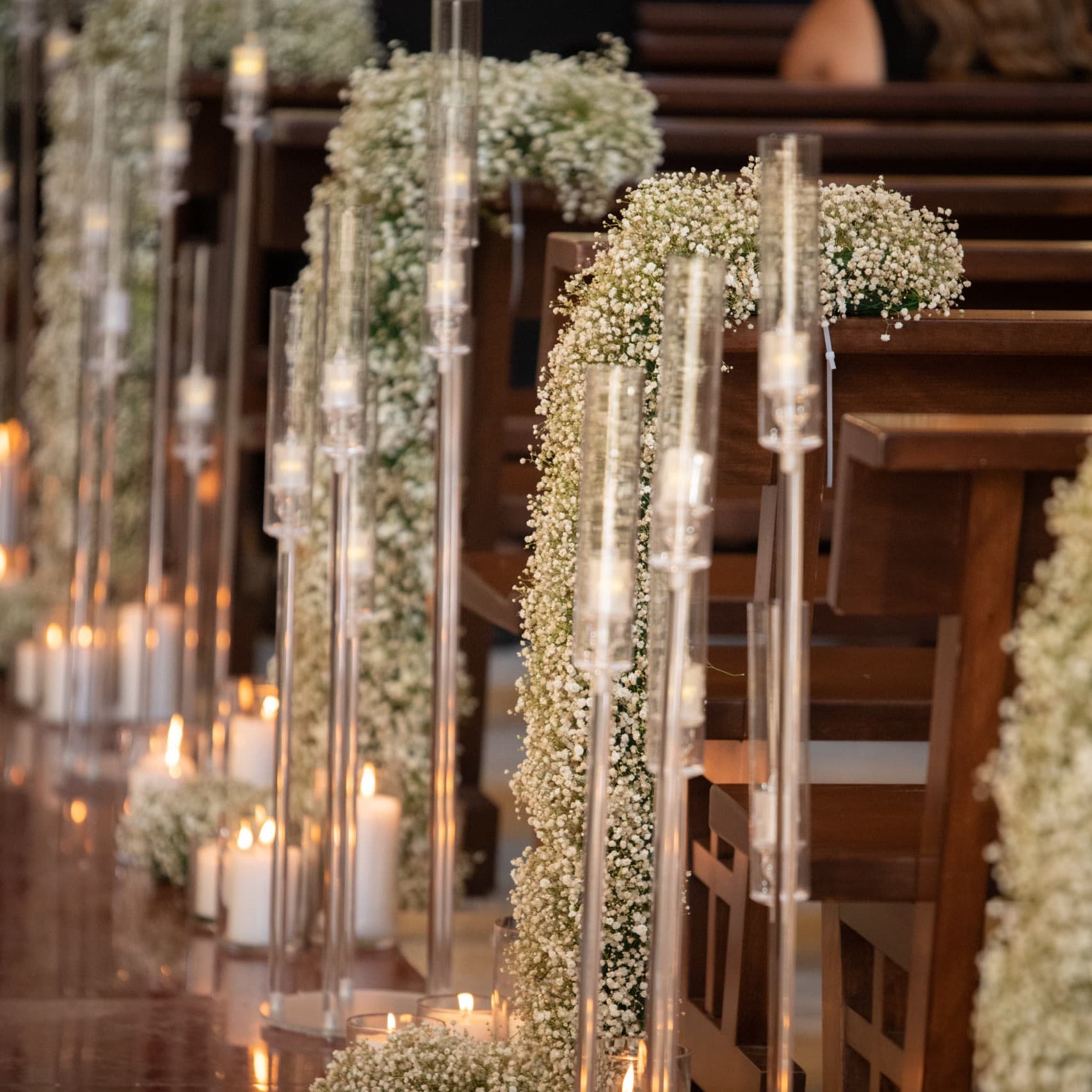 Decorative setup with candles and greenery on a wooden surface